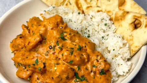 Delicious homemade butter chicken served with rice and naan.