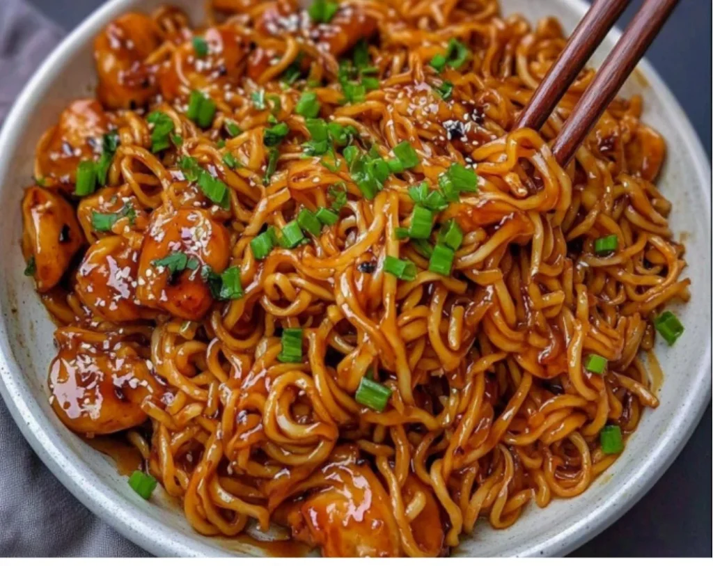 Delicious sticky garlic chicken noodles served in a bowl