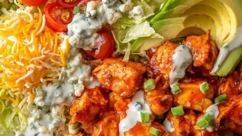 Delicious Buffalo Chicken Bowls with spicy chicken, fresh veggies, and tasty sauces