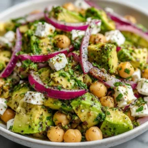 Delicious Chickpea Feta Avocado Salad topped with fresh ingredients.