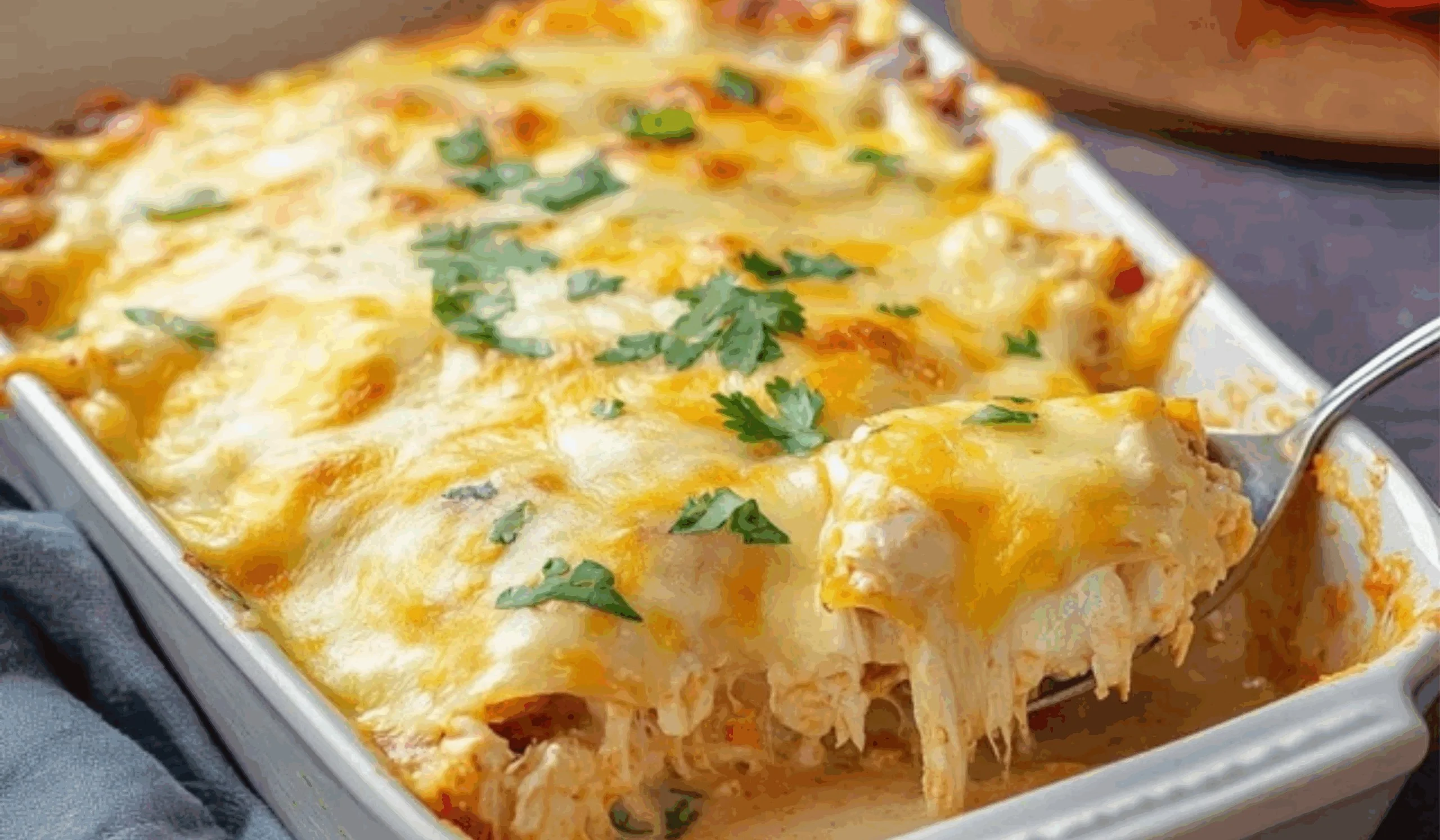Creamy white chicken enchilada casserole in a baking dish, ready to serve