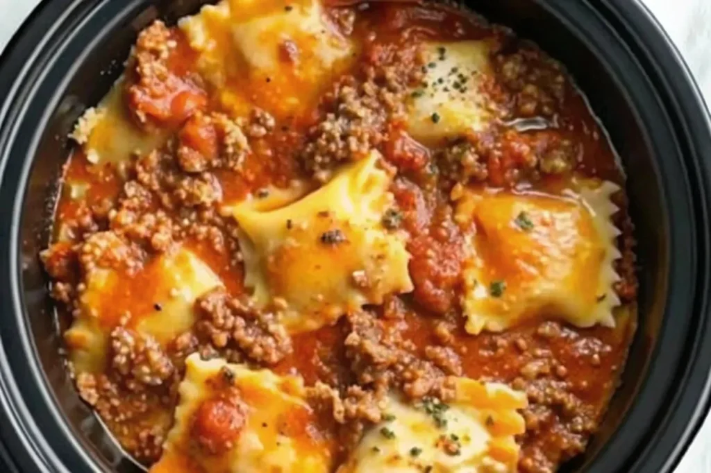 A steaming serving of Crockpot Ravioli Lasagna filled with cheese and sauce.