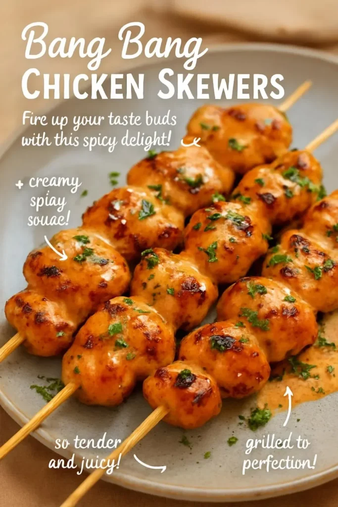 Delicious Bang Bang Chicken Skewers on a platter garnished with fresh herbs.