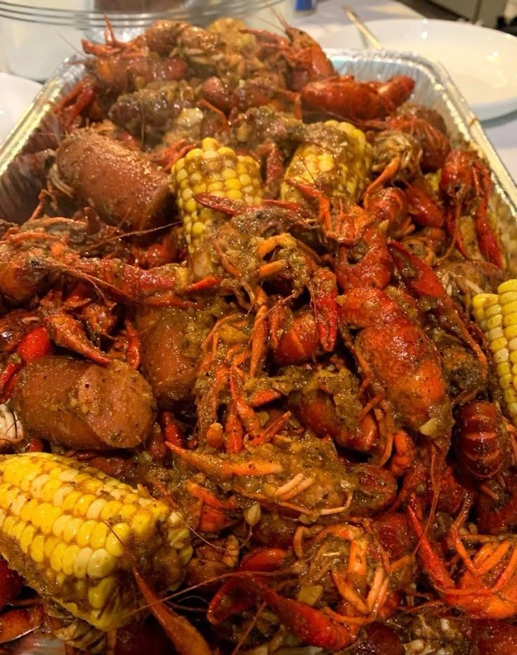 Seafood boil with garlic butter sauce served in a vibrant platter.