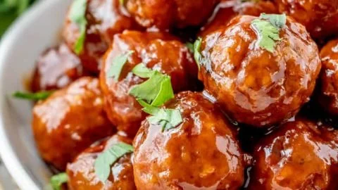 Honey BBQ Meatballs cooked in a crockpot, garnished and ready to serve